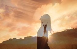 Woman,Celebrating,On,A,Mountain,Looking,Up,To,The,Sky.