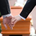 Religion,,Death,And,Dolor,-,Couple,At,Funeral,Holding,Hands