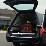 brown casket in the back of a hearse on the way to a preplanned funeral service